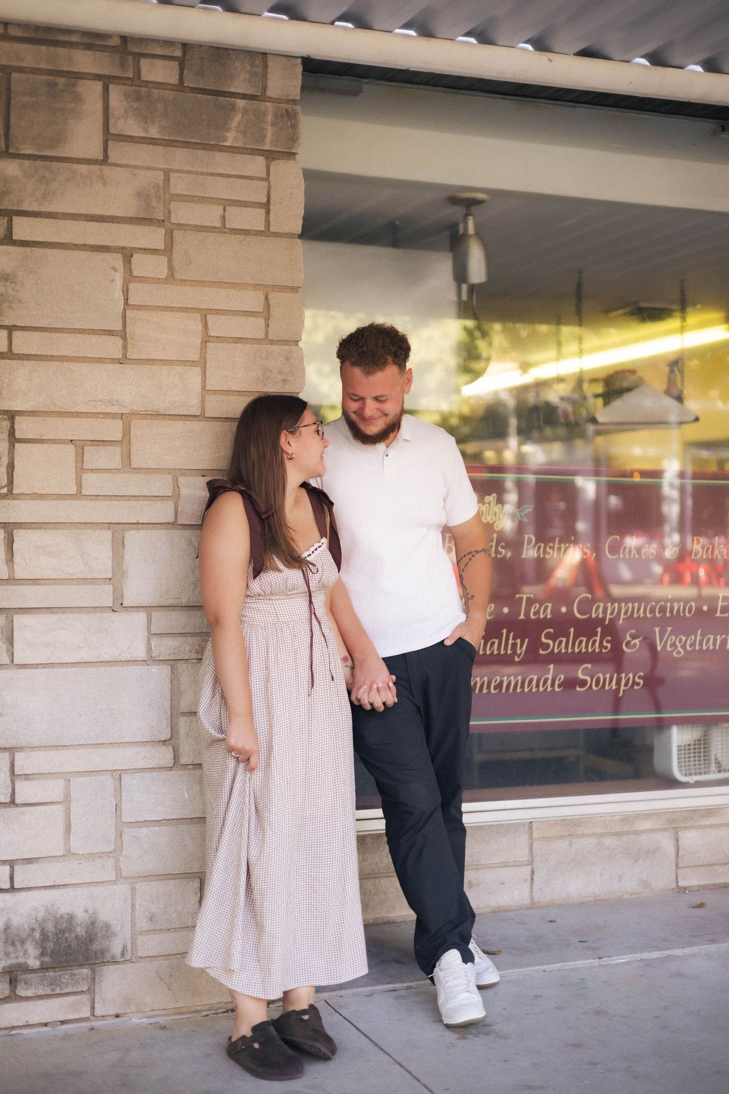 Outdoor uptown Normal summer engagement photos in Normal, Illinois