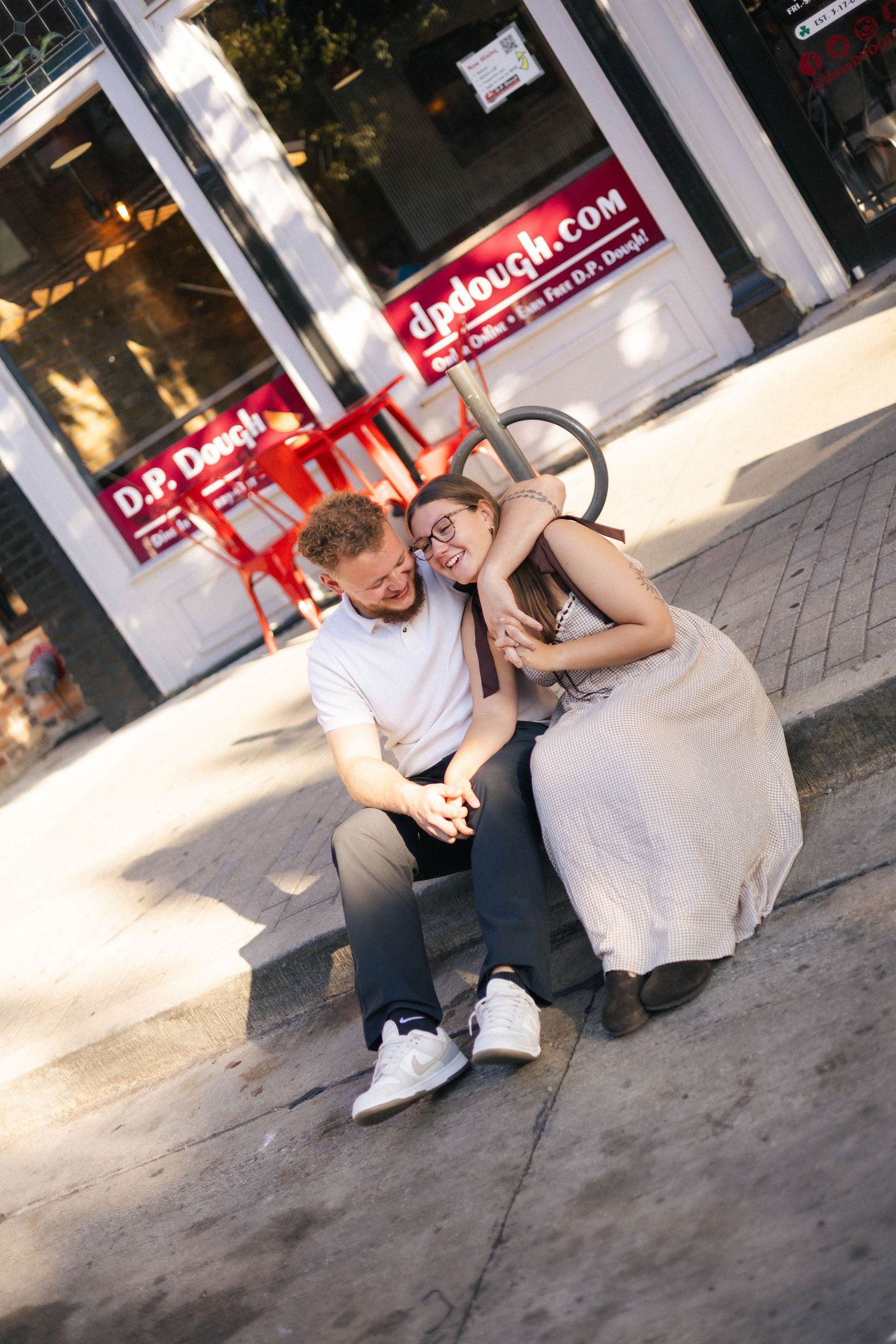 Outdoor uptown Normal summer engagement photos in Normal, Illinois