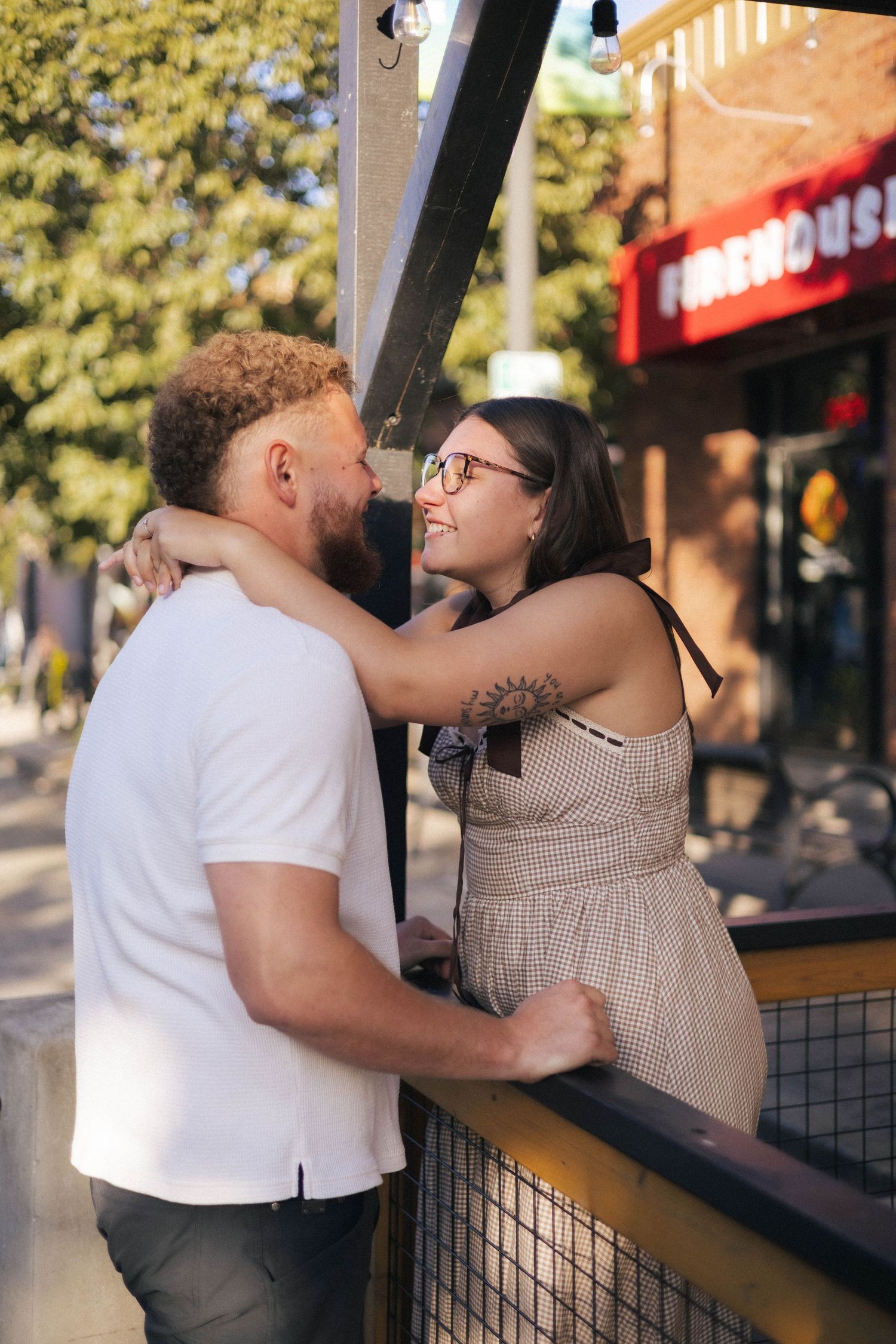 Outdoor uptown Normal summer engagement photos in Normal, Illinois