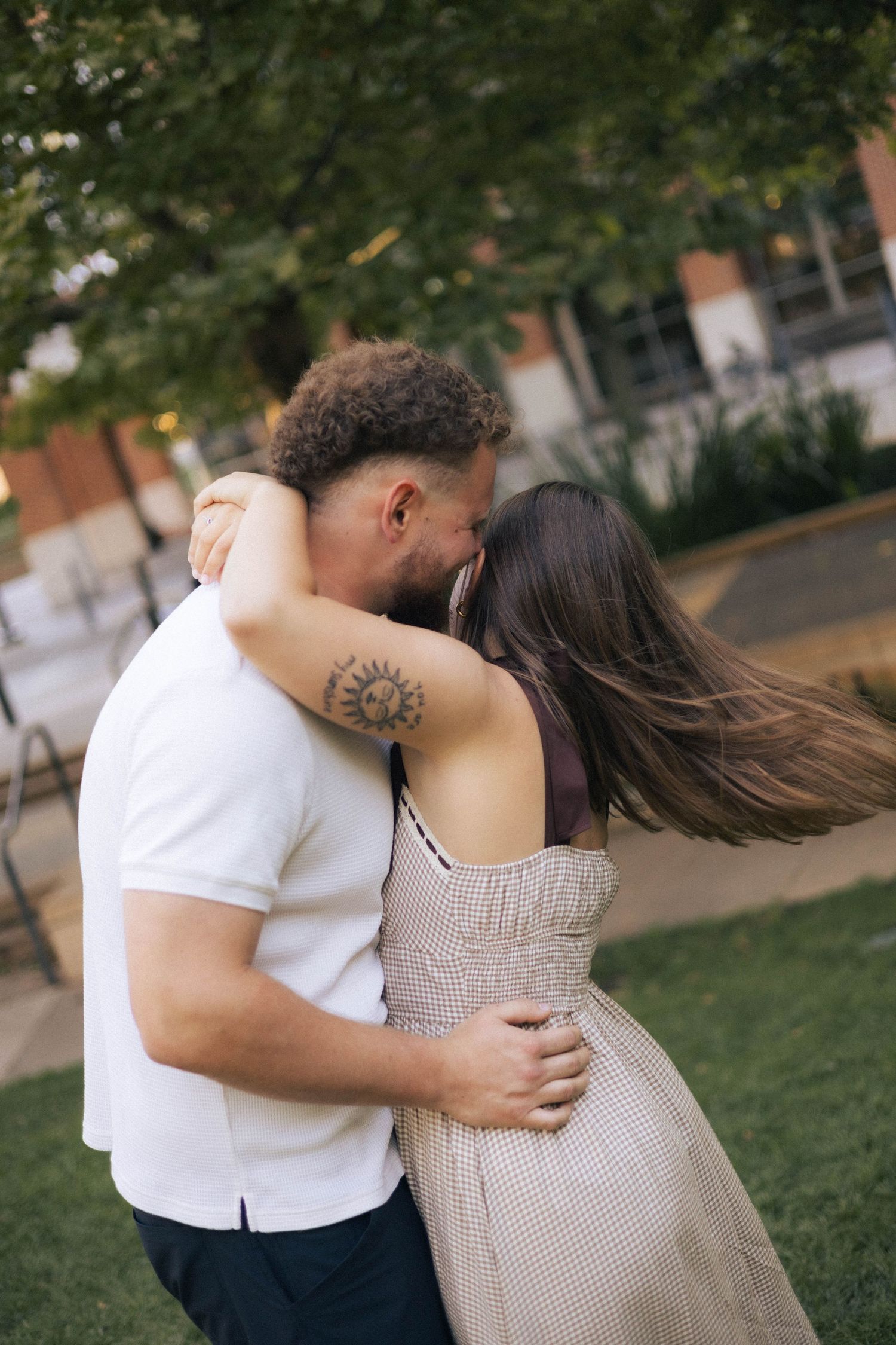 Outdoor uptown Normal summer engagement photos in Normal, Illinois