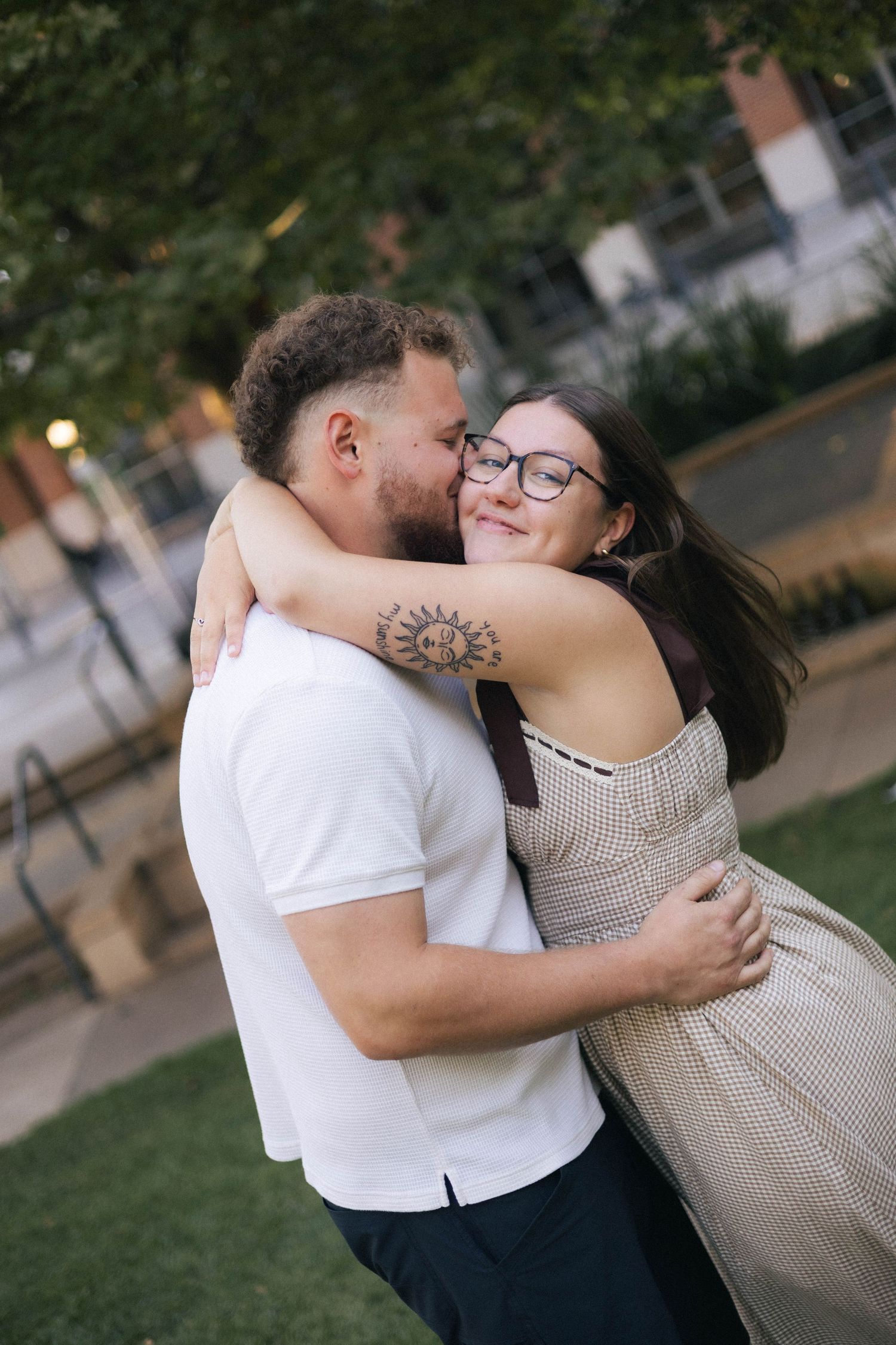 Outdoor uptown Normal summer engagement photos in Normal, Illinois