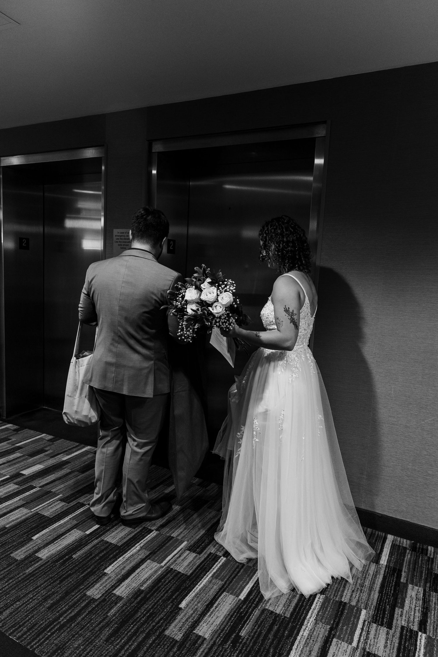 A black and white wedding photo sequence shows a couple walking down a hallway together from behind.