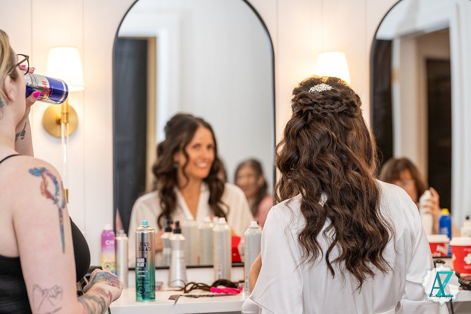 A row of decorative mirrors line the wall of an elegant bridal suite during wedding day preparations.