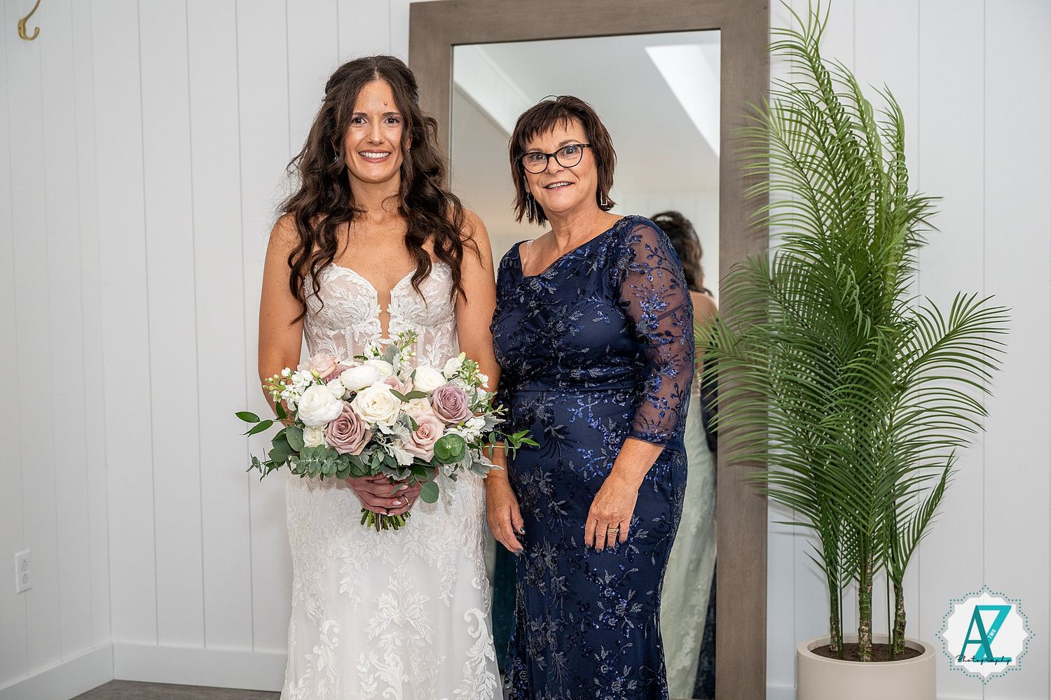 Wedding photos featuring bride in lace gown with bridal party member in navy sequined dress.