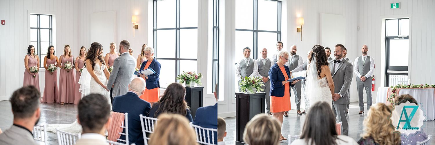 Wedding ceremony guests standing in an elegant white venue with large windows and natural light.