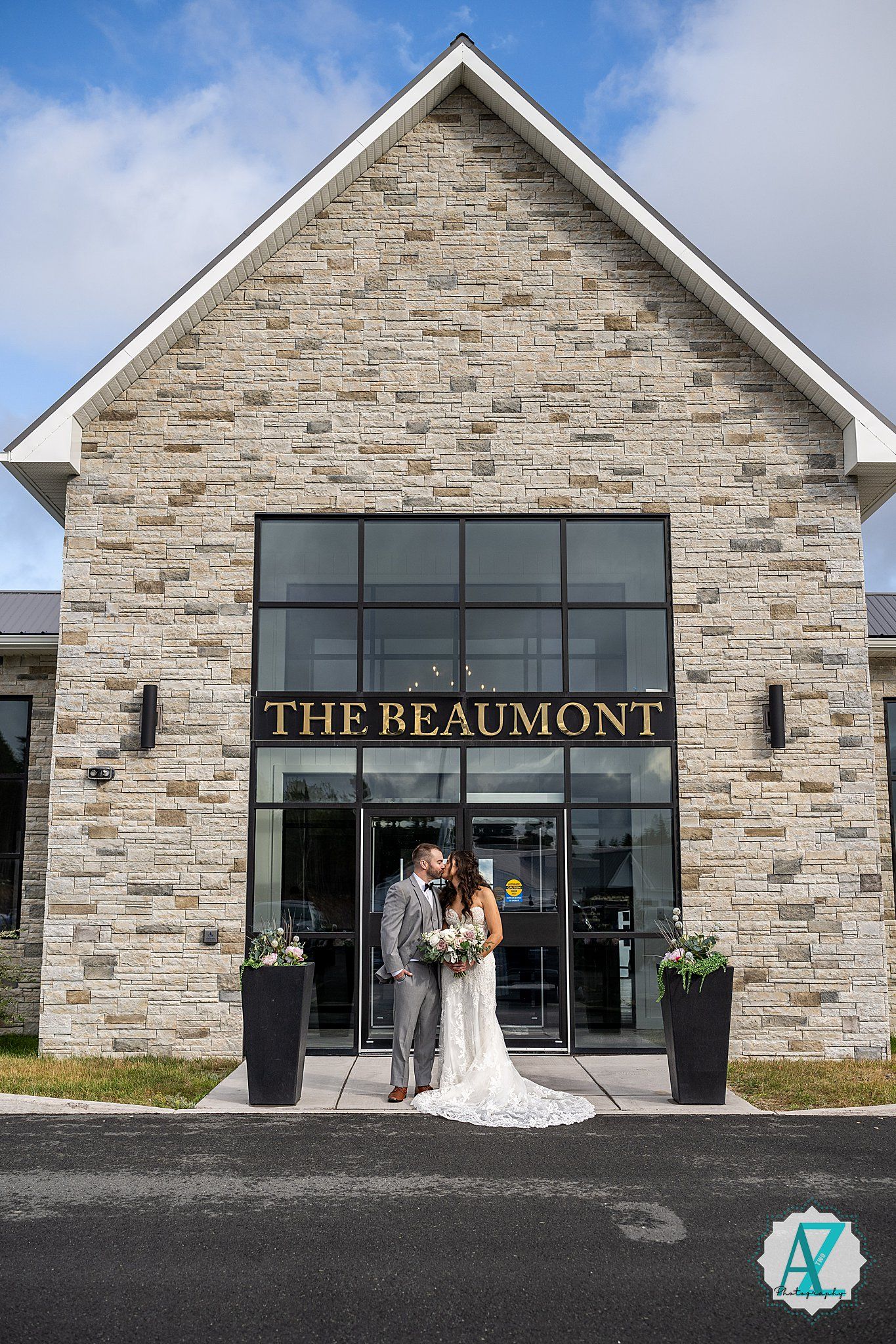 Exterior view of The Beaumont event venue featuring stone facade and modern glass windows.