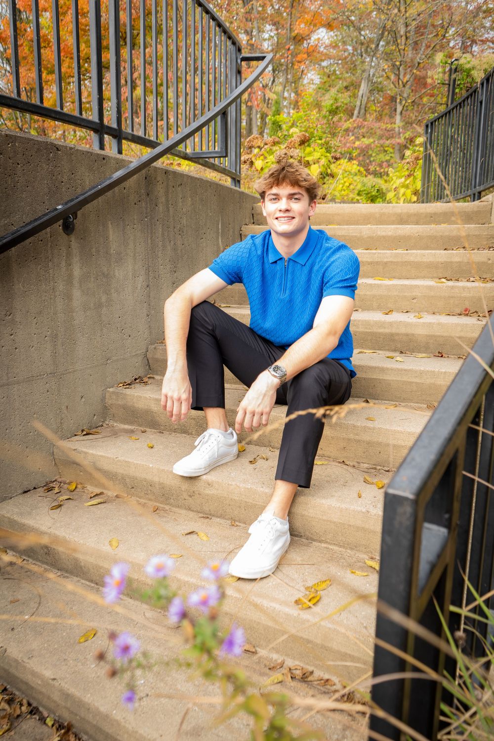 A collage of someone sitting on concrete steps wearing blue clothing and white shoes with autumn foliage in the background.