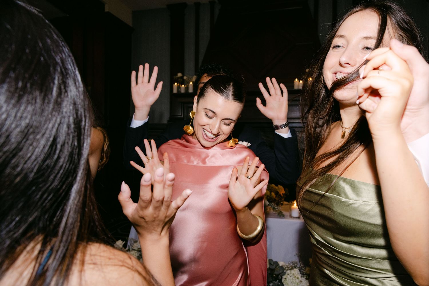 Energetic dancing and celebration at a wedding reception with guests in formal wear.