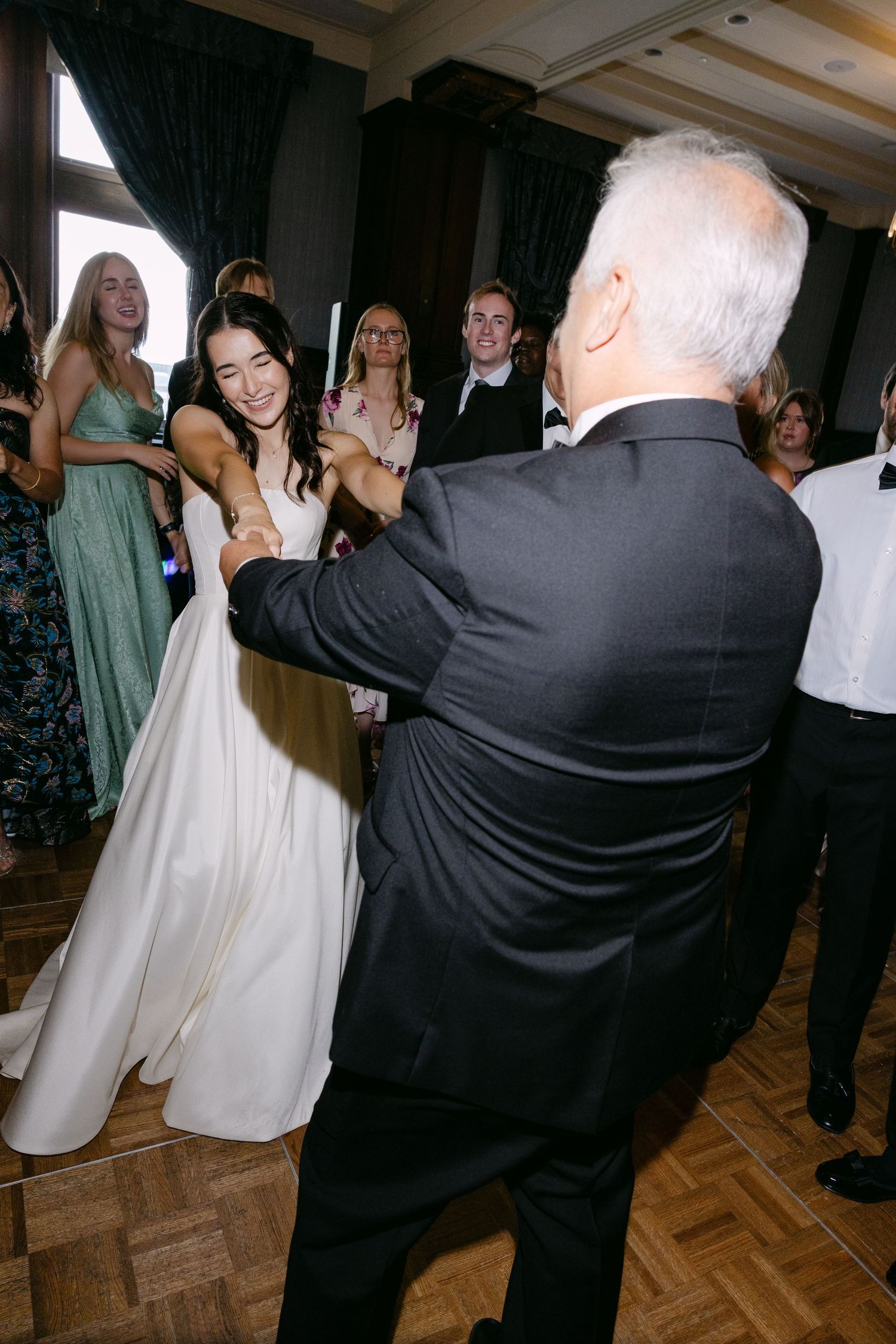 Guests dancing and enjoying themselves at an elegant wedding reception.