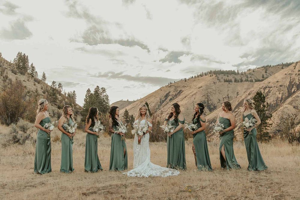 Bride and her bridesmaids in sage-green dresses candid moments at the American Homestead wedding venue. Spokane wedding photographer