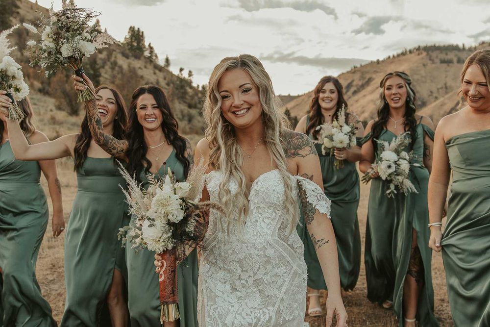 Bride and her bridesmaids in sage-green dresses candid moments at the American Homestead wedding venue. Spokane wedding photographer