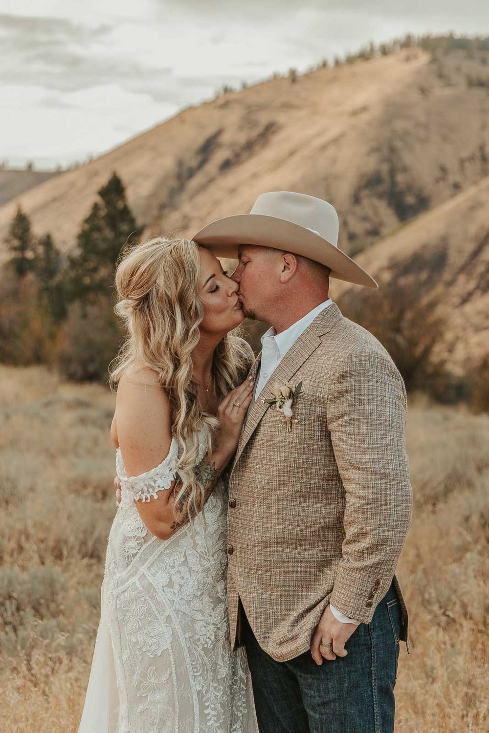 Bride and groom share a authentic cadid moment, surrounded by rustic beauty in Naches, WA. Photographed by a Washington wedding photographer