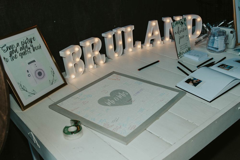 Rustic Country Wedding Reception in Yakima, WA. Unique guest book puzzle, Polaroid camera photo guest book, twinkly light wedding decor.