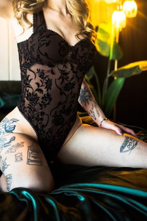 Intimate portrait featuring black lace and warm lighting.