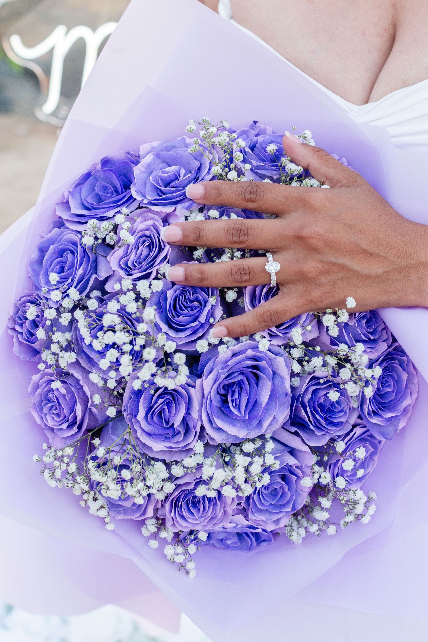 Marriage proposal. Ring shot. Hand on bouquet of purple roses. Río Grande, Puerto Rico.