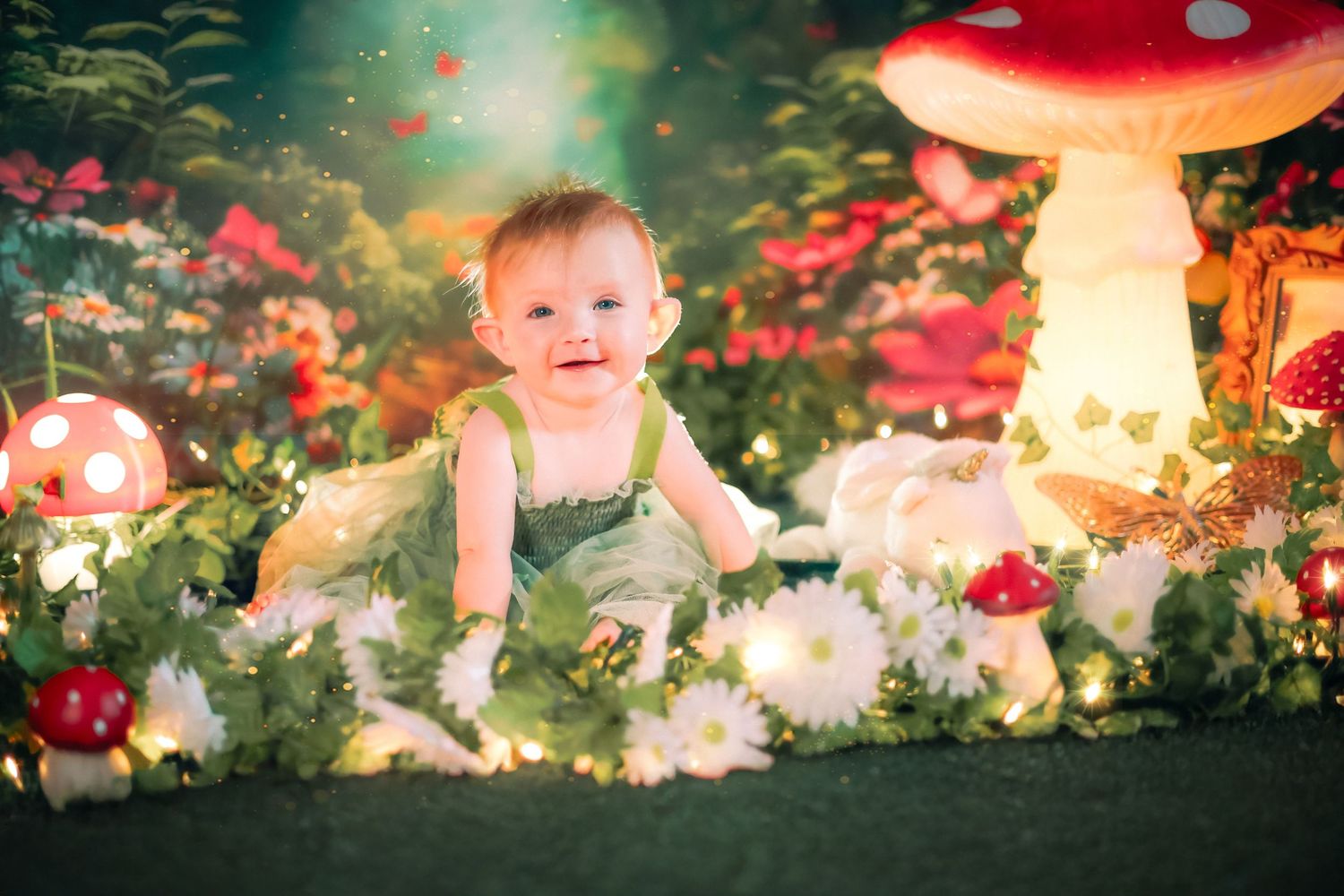 A baby in a green dress sits among glowing mushrooms and flowers in an enchanted fairy tale garden setting a home session in Lake Worth, FL.