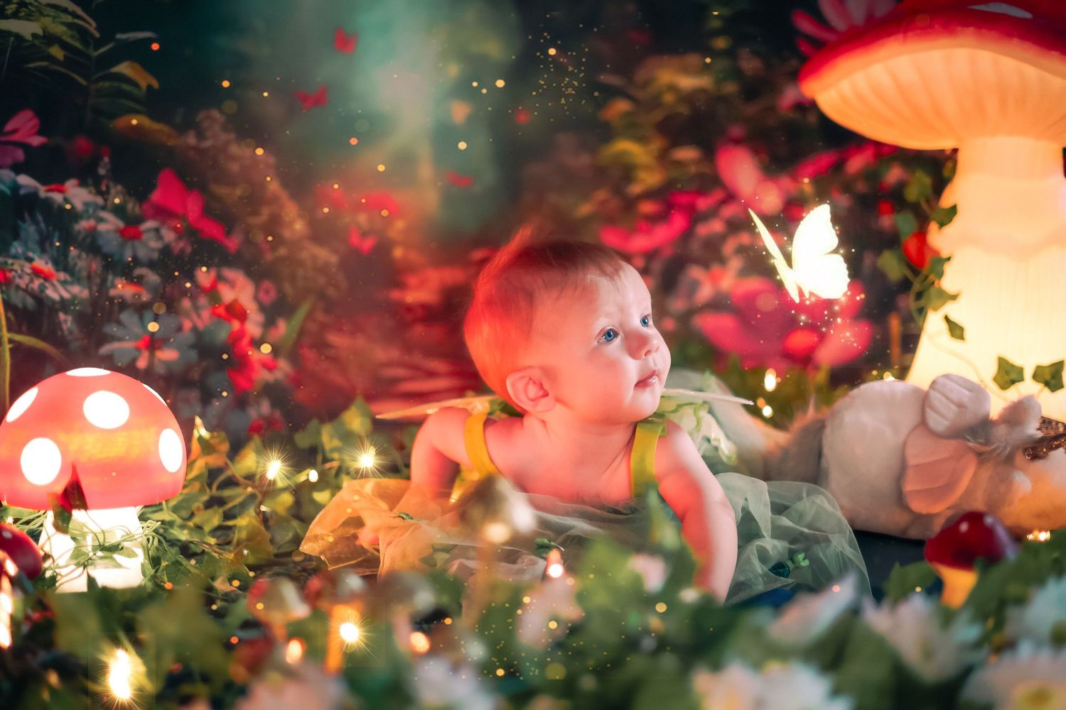 Baby in fairy tale mushroom garden with glowing lights and colorful flowers in enchanted fantasy photo shoot a home session in Lake Worth.