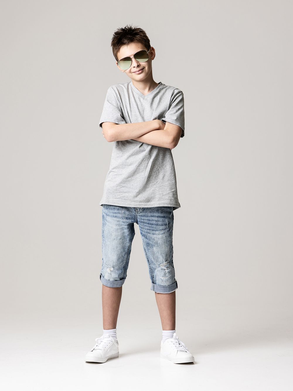 Black and white portrait of a smiling boy wearing sunglasses during a fun back-to-school photoshoot in Atlanta.