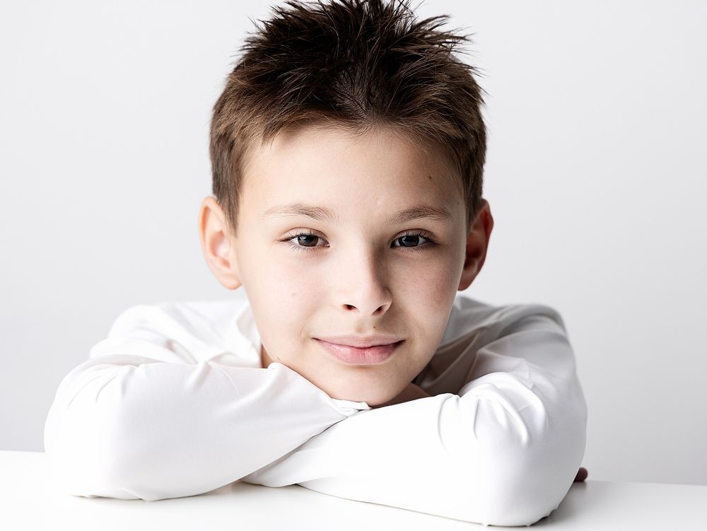 Natural close-up portrait of a smiling school-age boy photographed for back-to-school portraits in Atlanta.