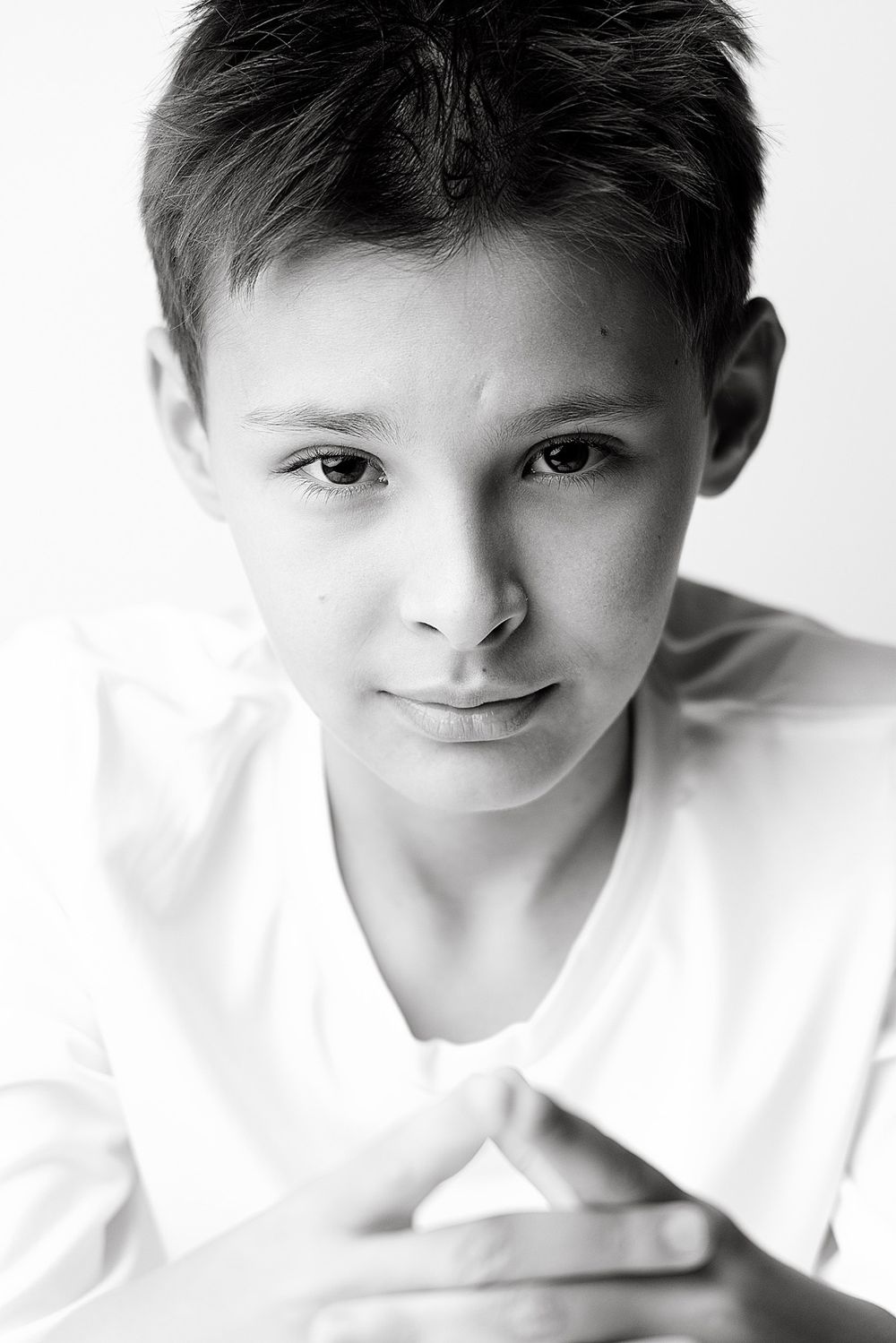 Black and white close-up portrait of a confident boy looking directly into the camera during a studio session in Atlanta
