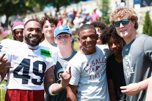 Patriots players and fans pose together during training camp fan appreciation day.