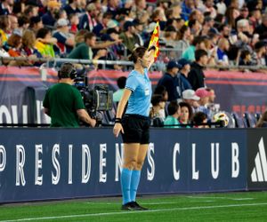 A crowded stadium watches intently as soccer players compete on the field.