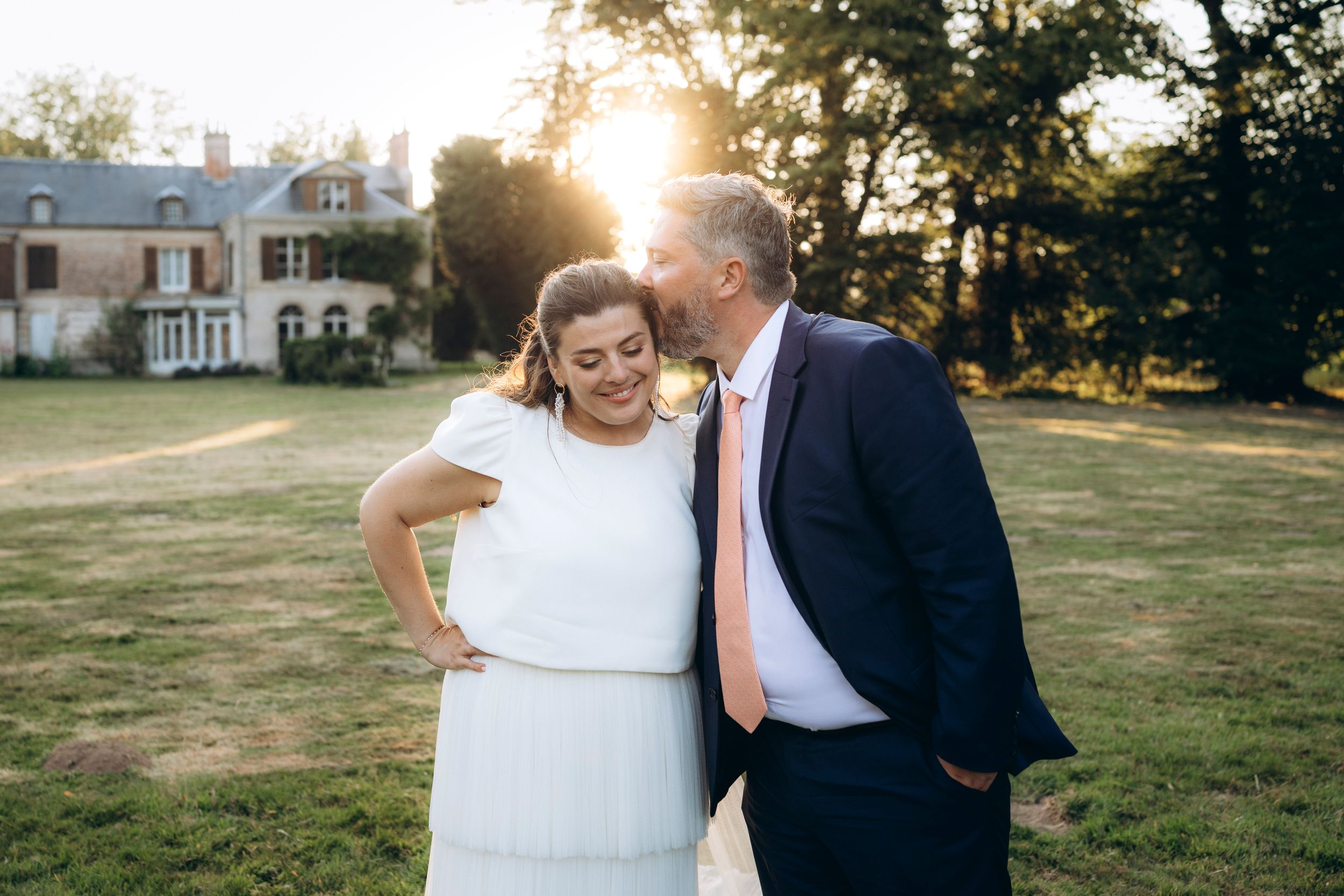 A romantic dance silhouette under stone archways with warm lighting.