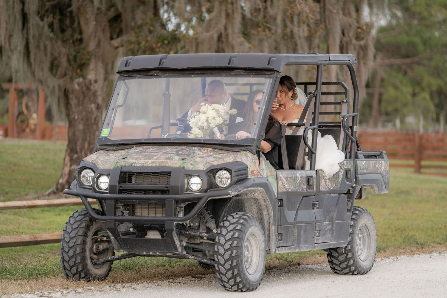 Bride and groom riding the ranch UTV between portrait spots at a Rockin' H Ranch wedding in Palm City, FL