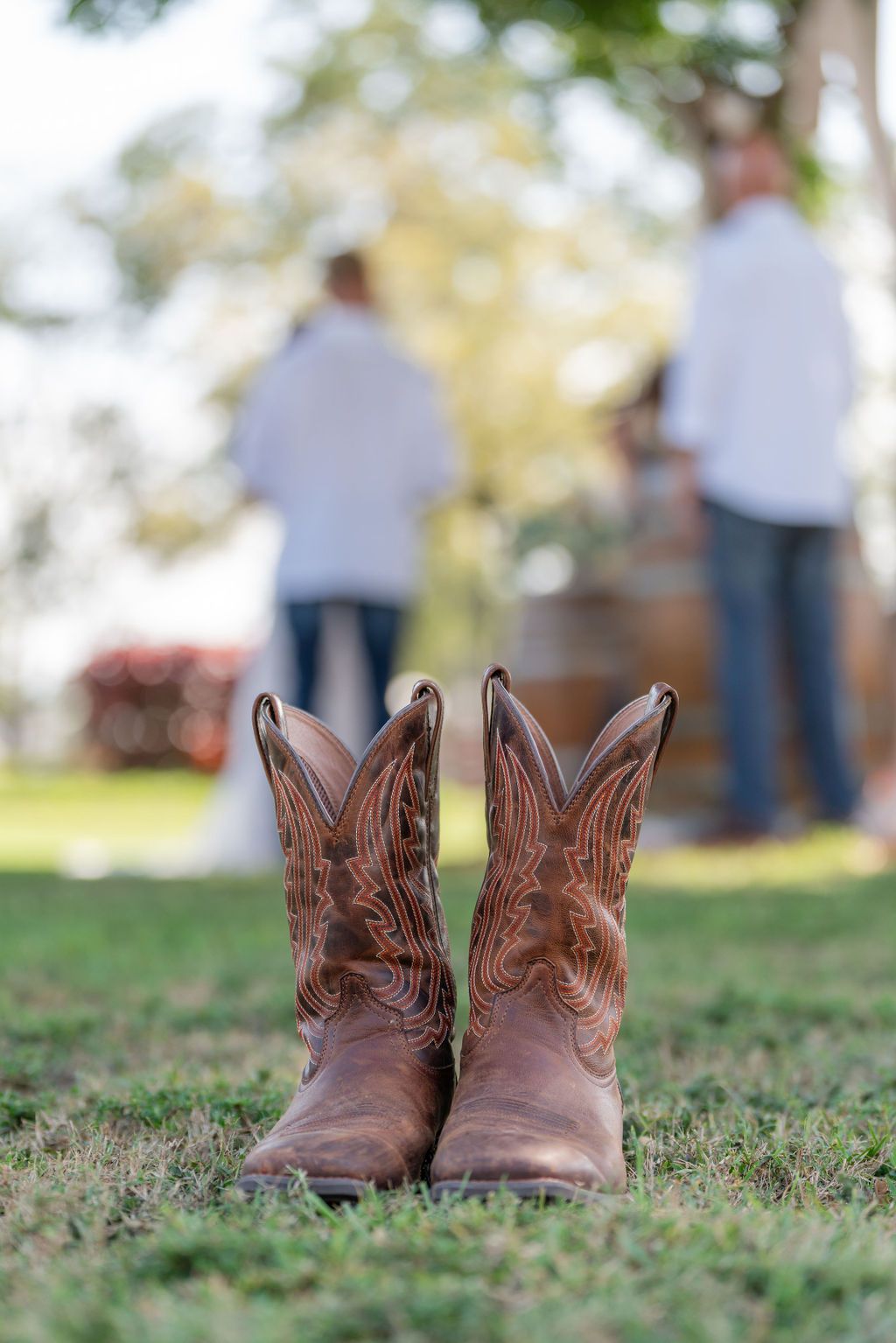 Cowboy boots in the grass with a couple during their ceremony at Rockin' H Ranch in Palm City, FL
