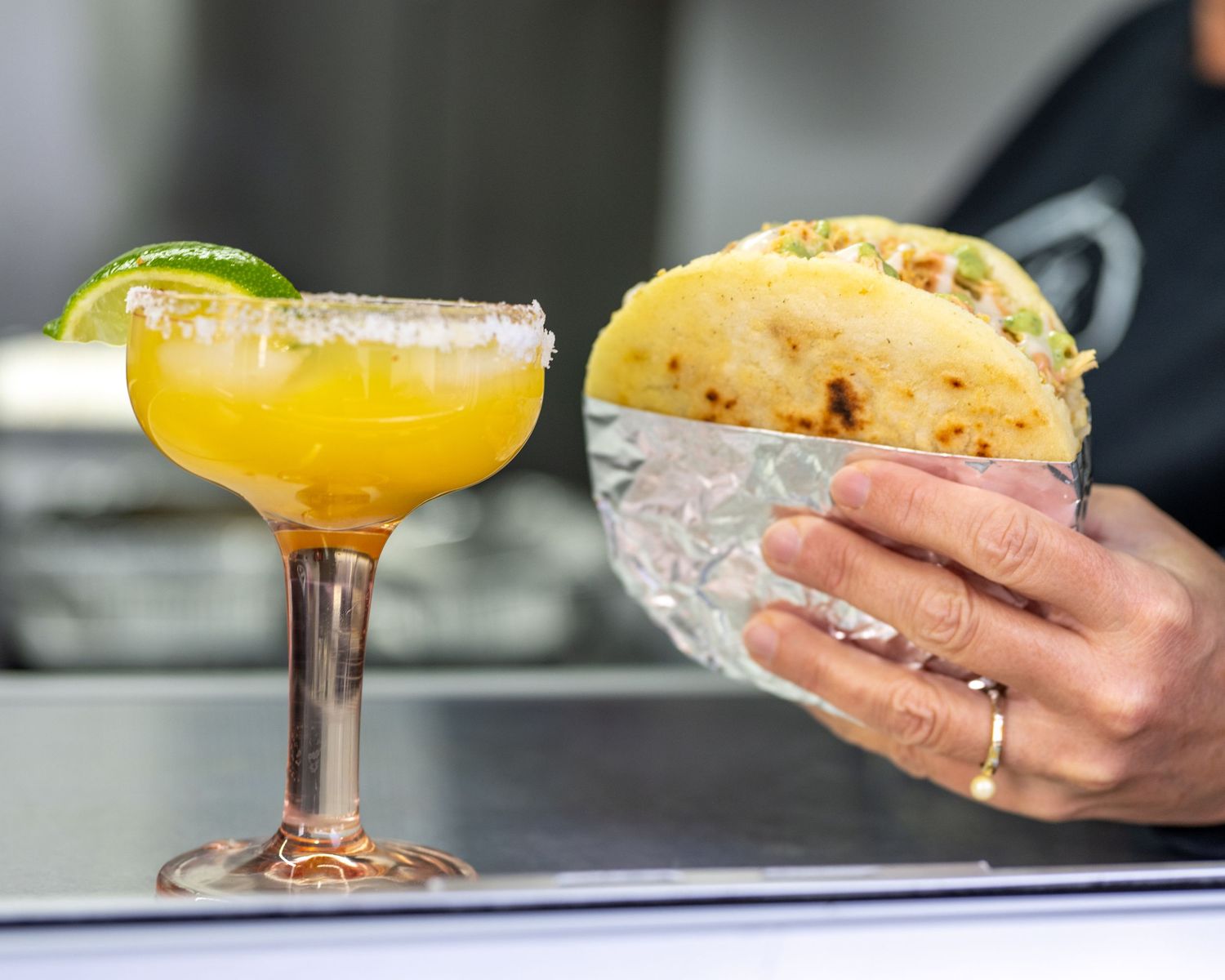 Cali Arepa Food Truck Branding Photography Manchester, New Hampshire. Hand holding arepa and margarita