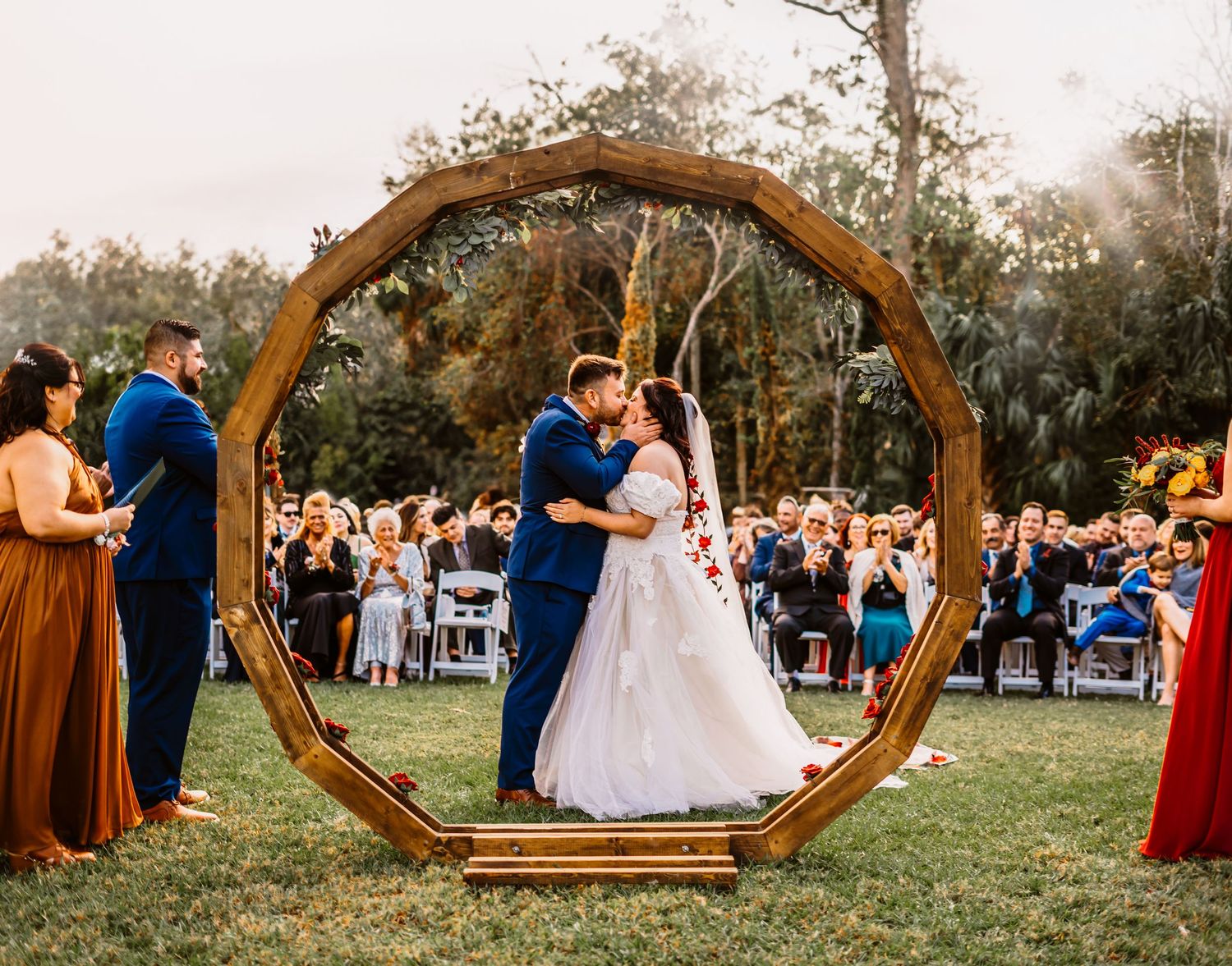 Channel Side Club in Palm Coast Florida. Wedding photography of bride and groom's first kiss. Family and friends are visible, clapping.