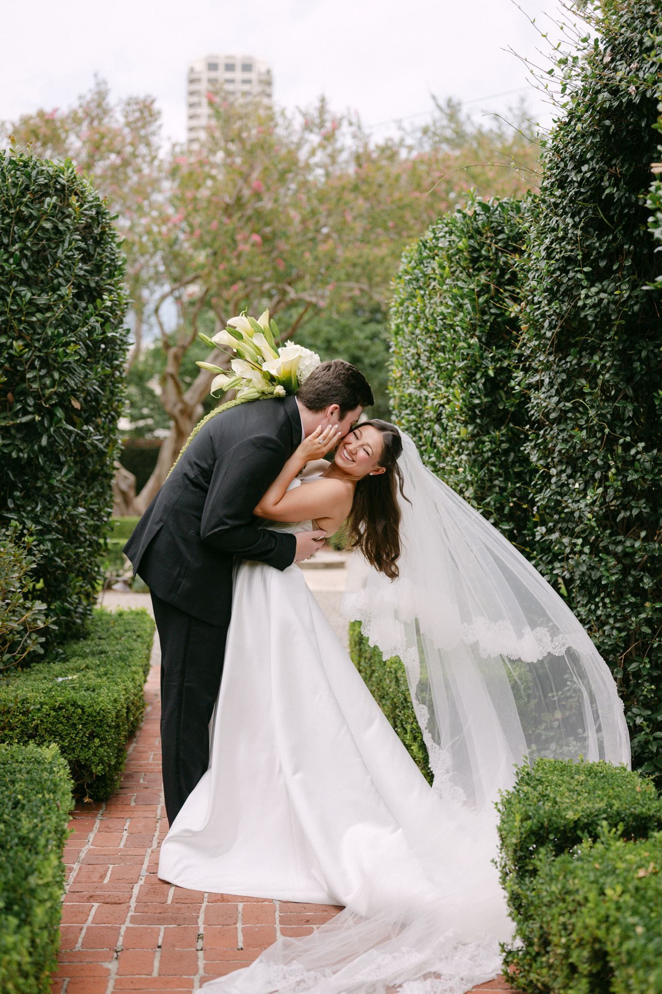 Bride and groom sharing a kiss in the garden.