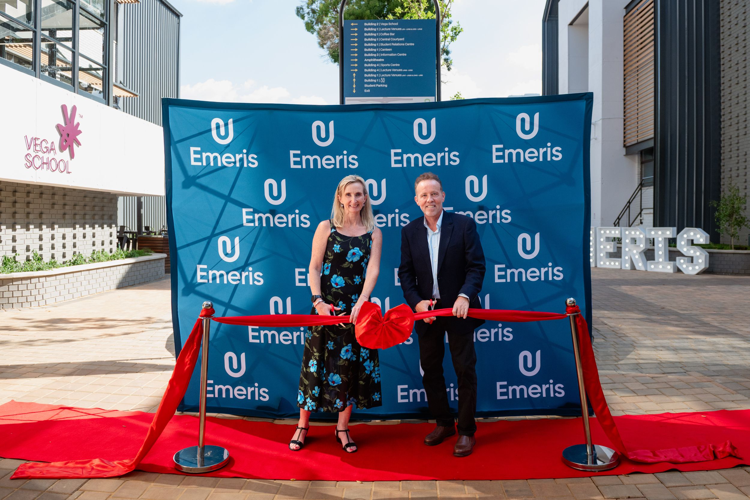 Guests posing on the red carpet at an Emeris Sandton Campus corporate event.