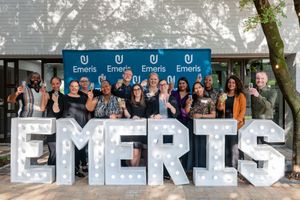 Group event portrait capturing a joyful celebration at Emeris Sandton Campus.