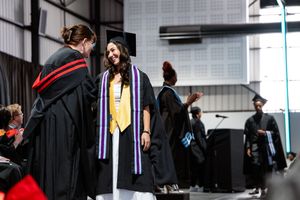 Graduate receiving recognition during the formal Emeris Sandton Campus graduation ceremony.