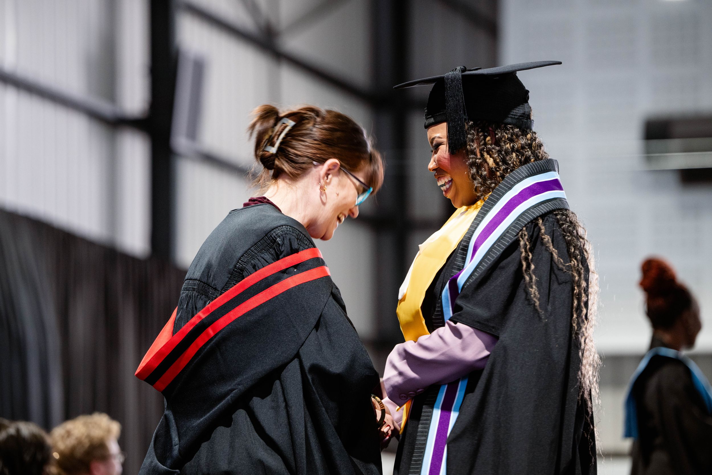 On-stage moment as a graduate is honoured at the Emeris Sandton Campus graduation.