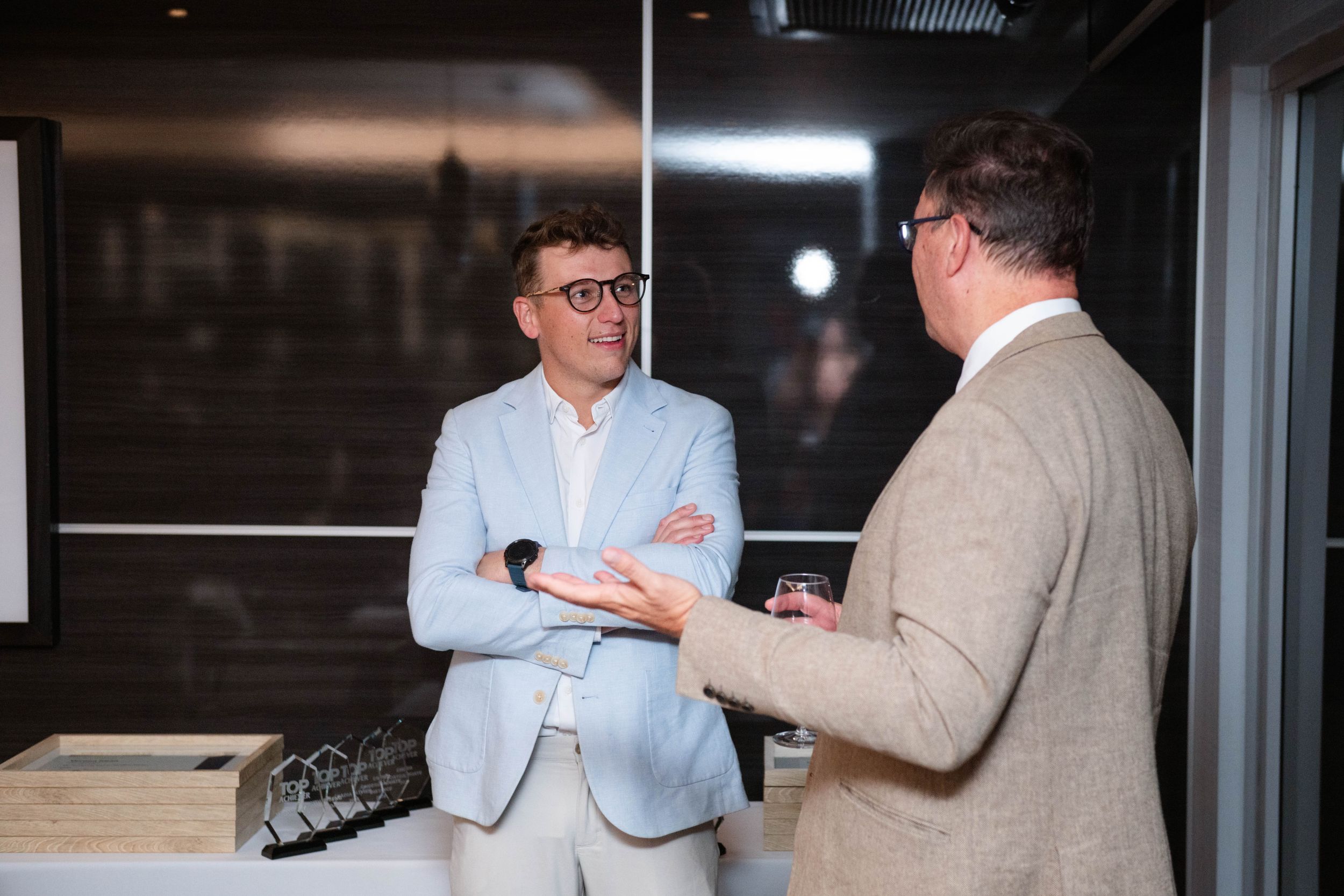 Guests networking and chatting during the Emeris Top Achiever Awards event.