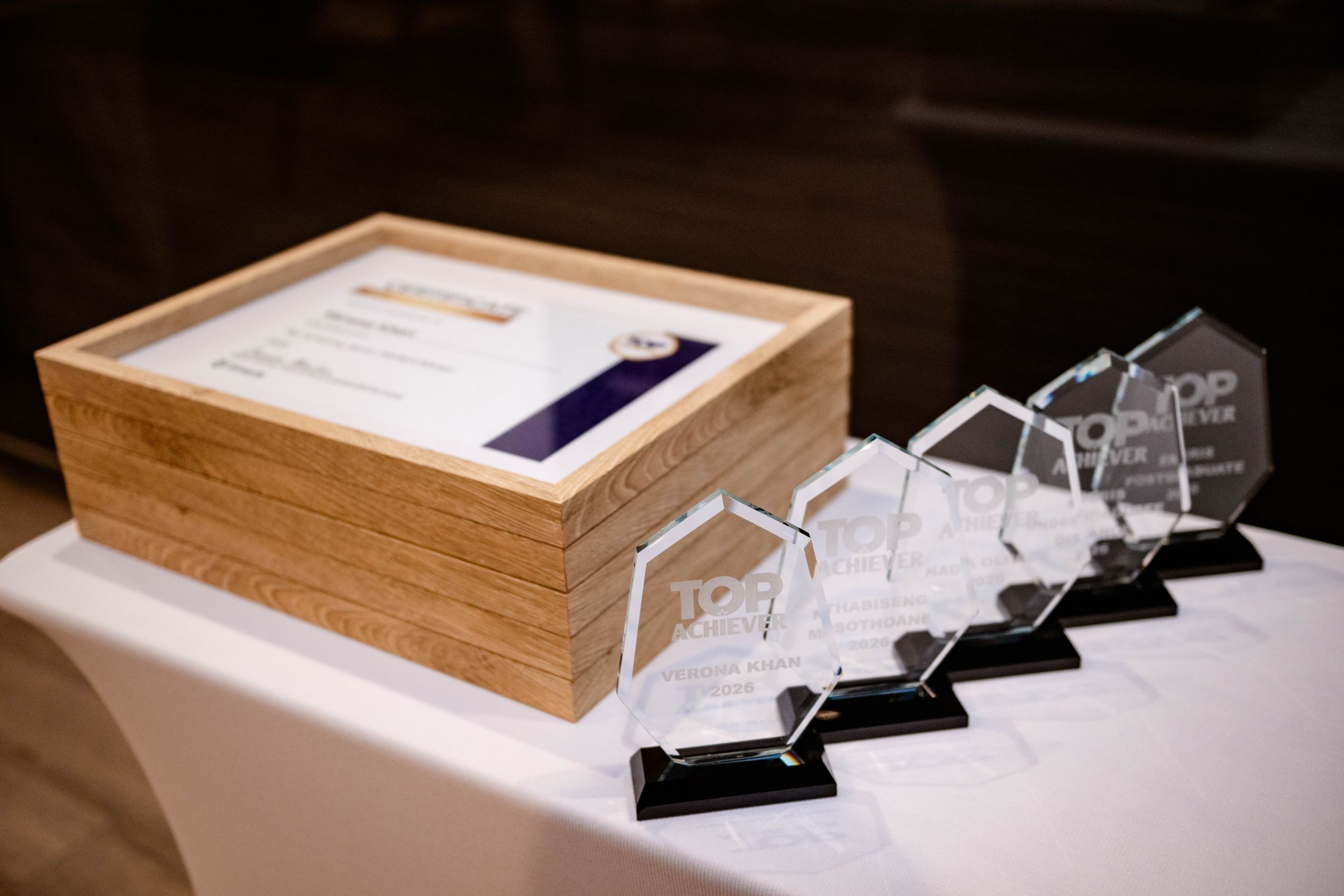Awards and certificates displayed for the Emeris Top Achiever Awards ceremony.