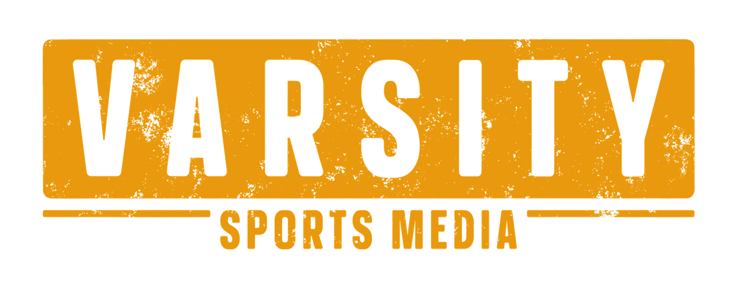 Varsity Sports Media logo featuring bold white text on an orange distressed background.