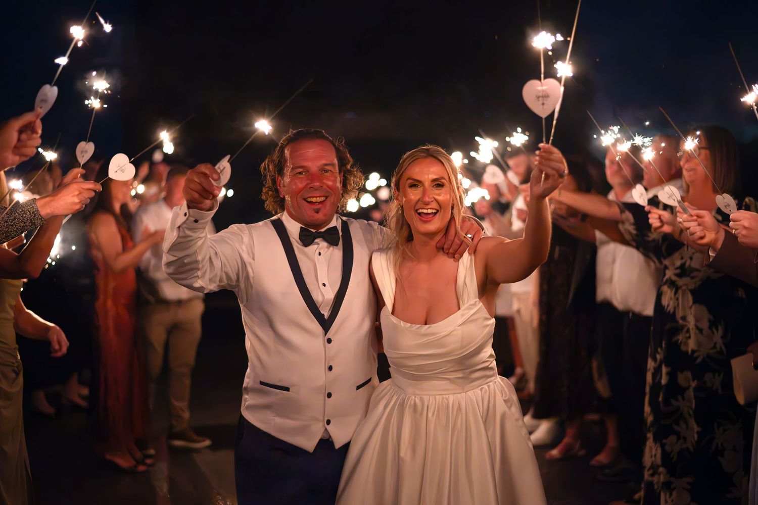 Bride and groom walk through sparkler tunnel at night wedding celebration. Leeds wedding day, Yorkshire Sparklers, Yorkshire UK