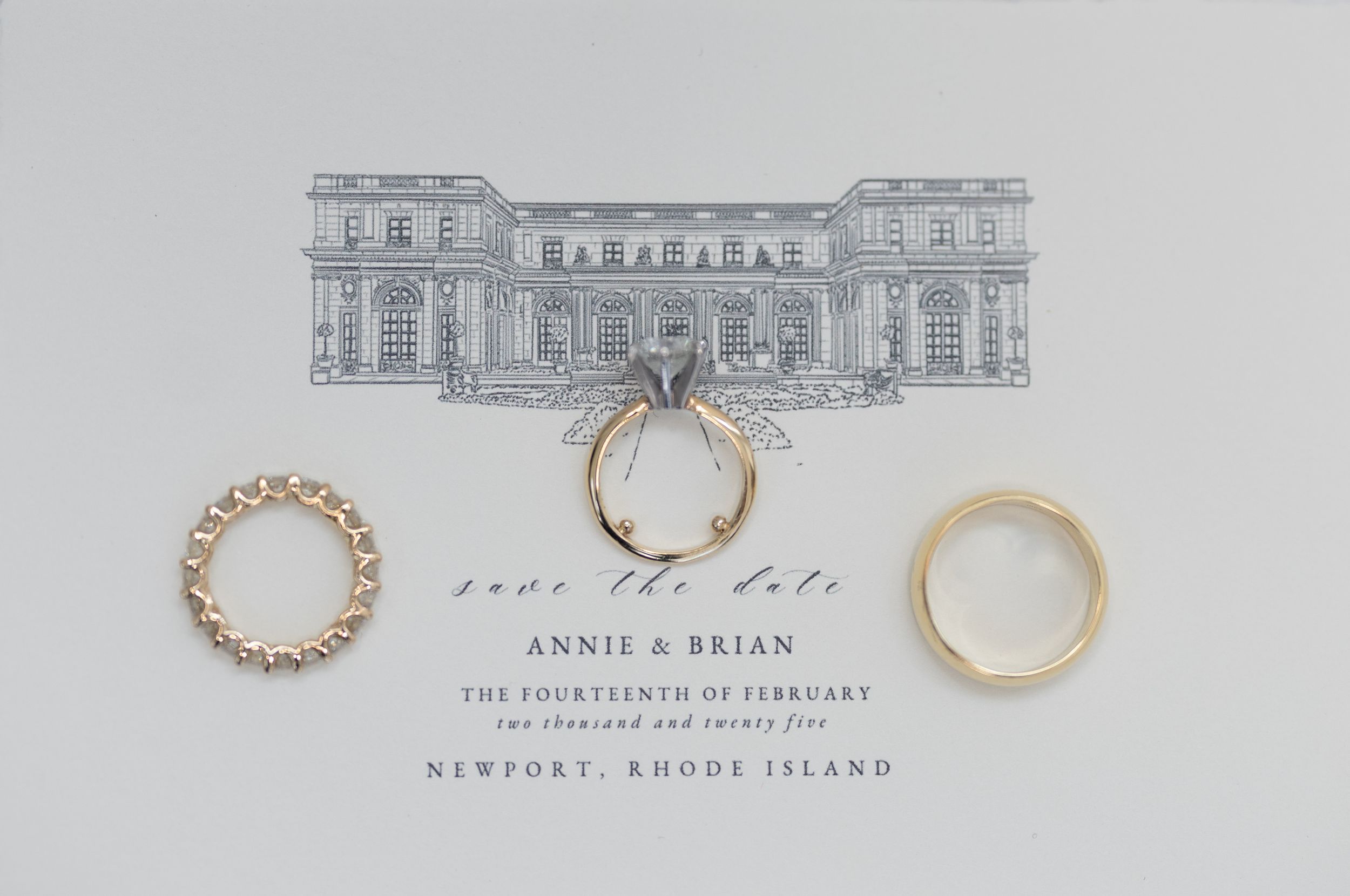 Wedding save the date card for Annie and Brian in Newport, Rhode Island with gold rings and venue illustration.