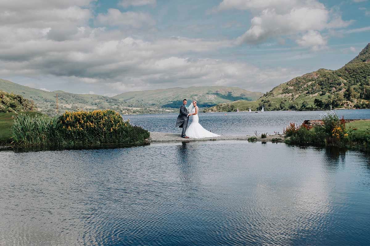 Bride and groom embrace on the iconic island at Inn on the Lake wedding venue