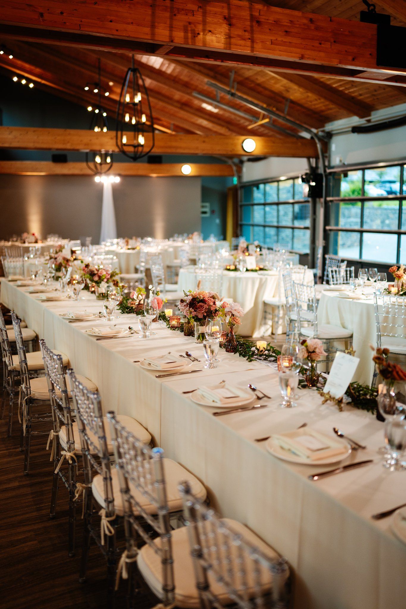 Reception long tables under timber beams at Azuridge