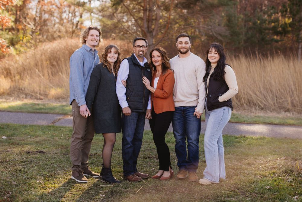 Extended family gathering for outdoor portraits during autumn with natural lighting. Twin Cities, Decorah Iowa wedding photography