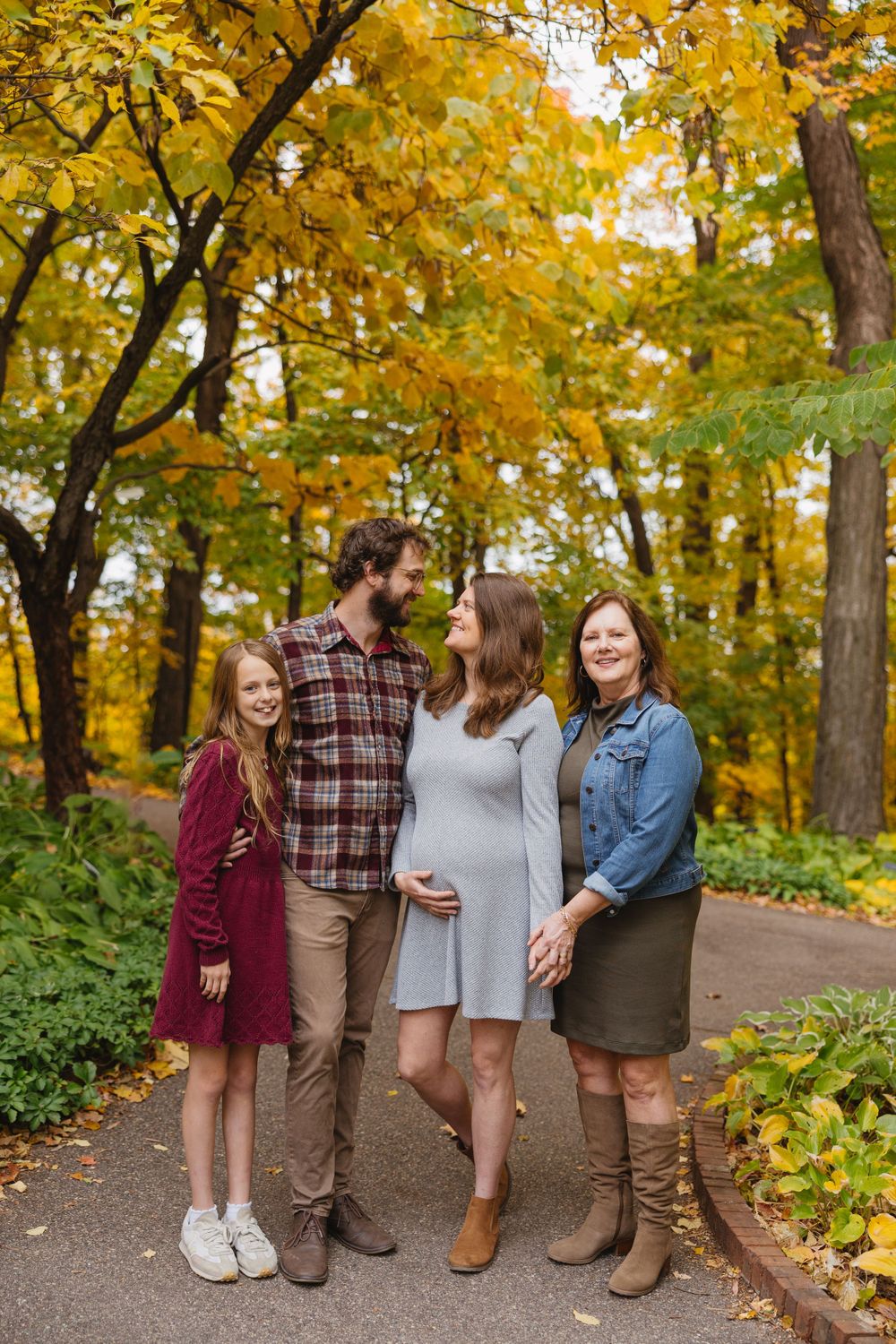 Group photo session in a park with beautiful fall foliage and yellow leaves overhead. Twin Cities, Decorah Iowa wedding photography