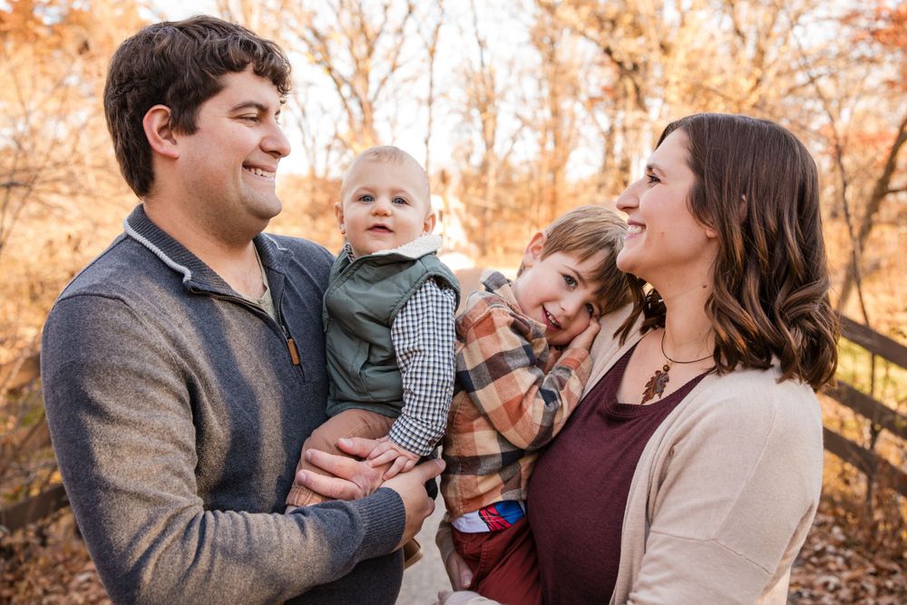 Candid family moments captured during an autumn photoshoot with warm sunset lighting. Twin Cities, Decorah Iowa wedding photography