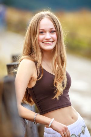 A series of outdoor portrait photos showing a person in a brown top and light-colored skirt against a blurred background.
