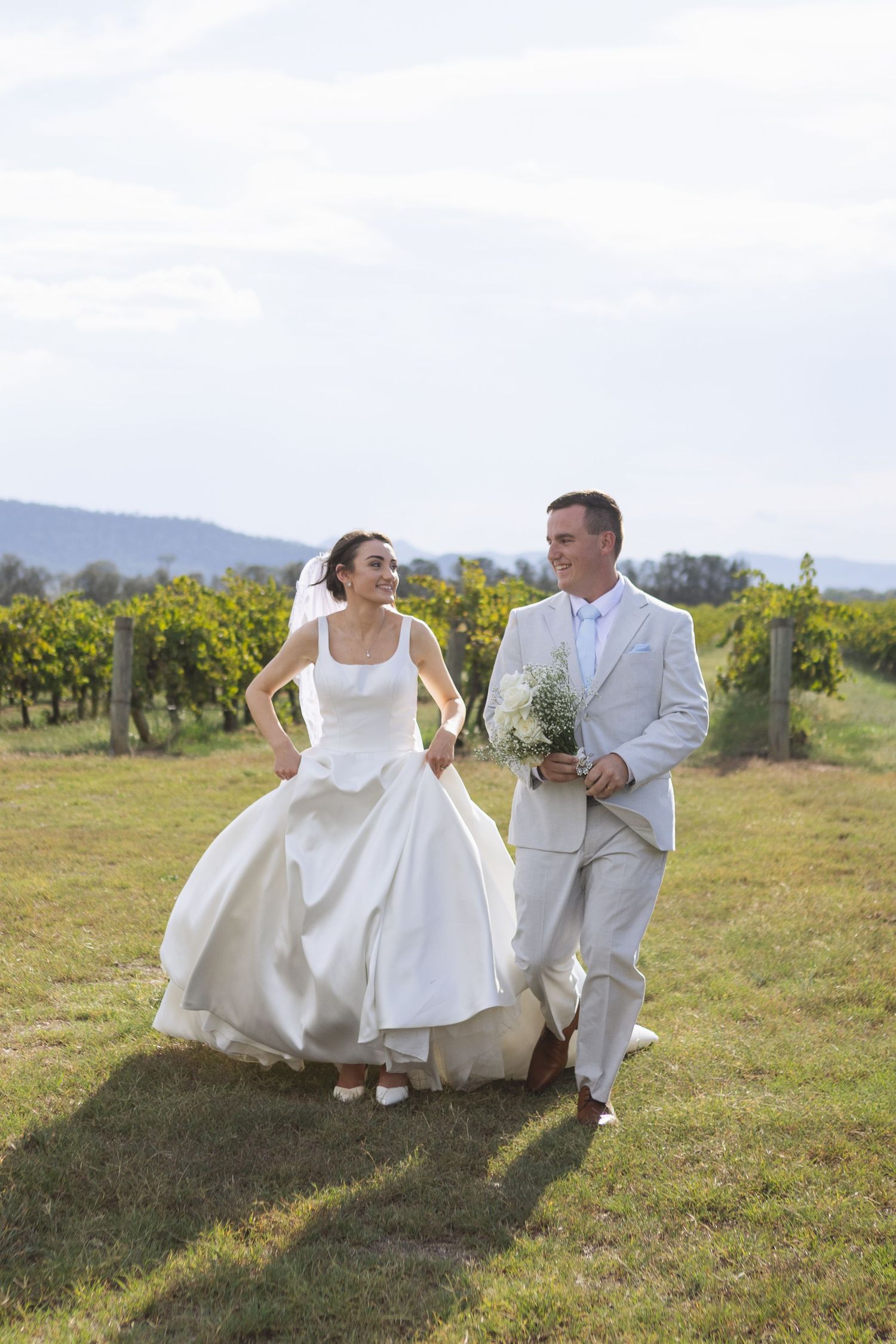 Bride and groom running at Two Rivers Winery Wedding in Denman