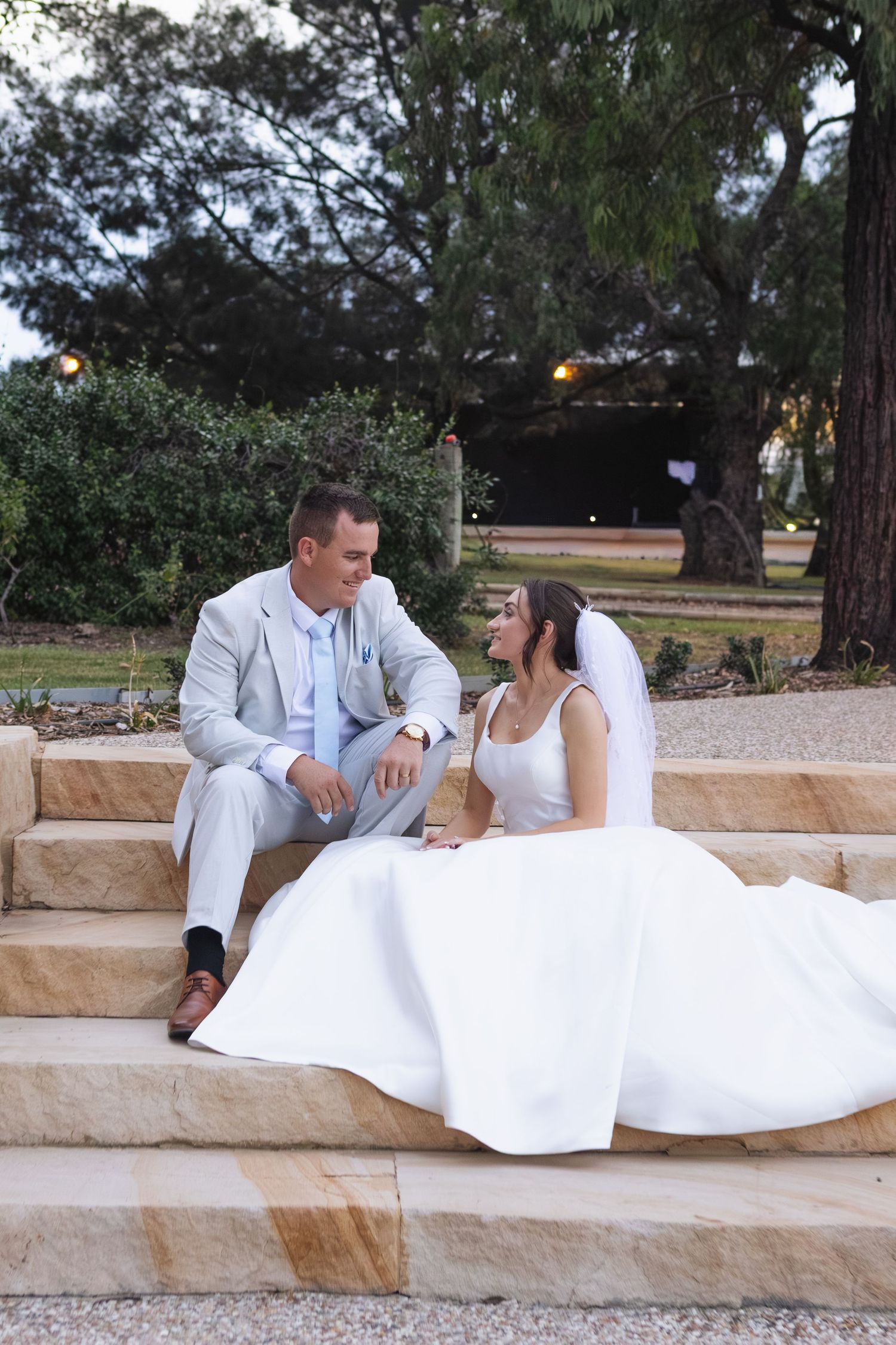 Bride and groom sitting and smiling at Two Rivers Winery Wedding in Denman