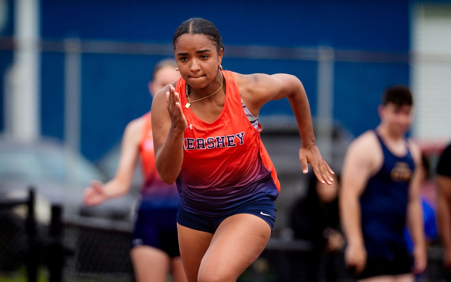 Hershey Trojans sprinter racing vs. Cedar Cliff, by Deanna Fox, SportsFox Photography, Hershey PA